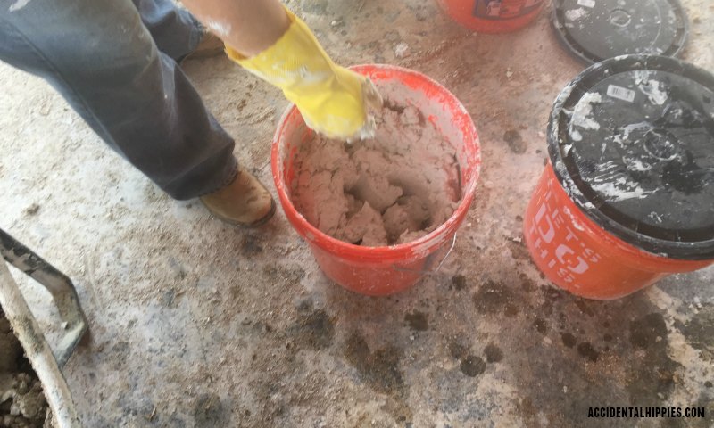 Mixing lime putty for making cordwood mortar. Learn more about how we make our cordwood mortar here.