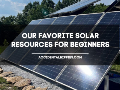 Text: Our Favorite Solar Resources for Beginners, AccidentalHippies.com Image: solar panels in a row on top of gravel with a blue sky in the background